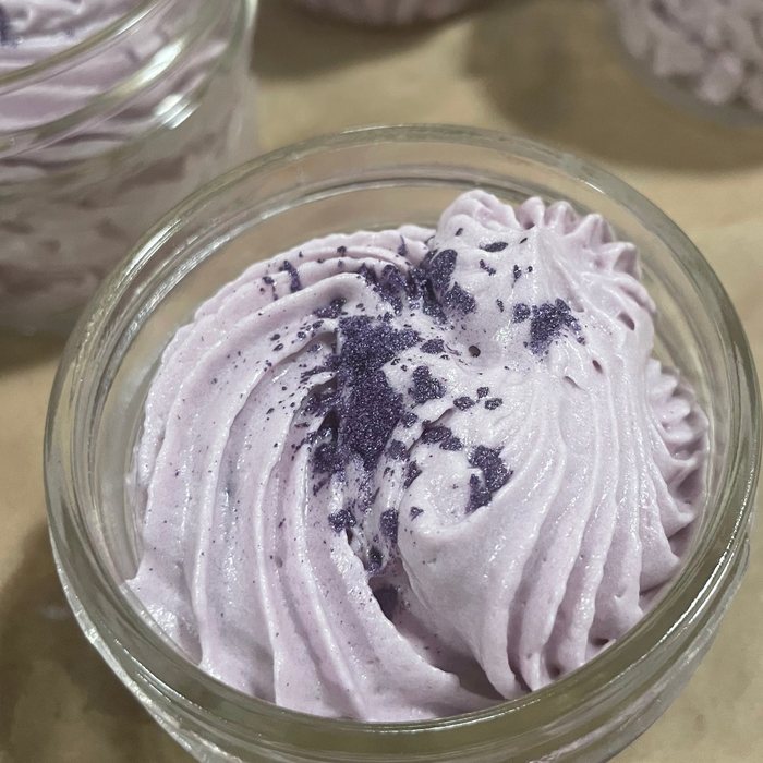 Whipped butter piped into a glass jar and dusted with purple shimmer